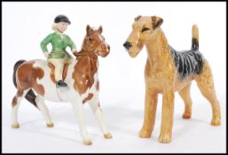 A 20th Century Beswick ceramic Skewbald Pony with a female rider, in green jacket, stamped to base