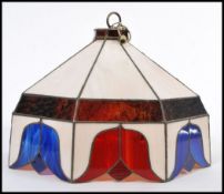 A vintage Tiffany style lamp shade having coloured leaded stained glass panels. Tulip pattern with