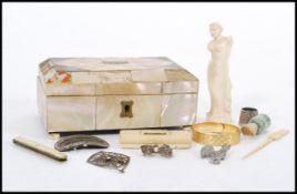 A 19th century mother of pearl jewellery box having a figure of Venus De Milo, fruit knife brooch