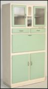 A vintage retro mid 20th Century all in one kitchen larder cupboard having pistachio / mint green