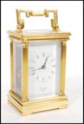 A 20th century modern Comitti of London brass cased carriage clock with Roman numeral chapter