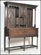 A good 1920's oak Geometric moulded commonwealth dresser. Raised on barley twist legs with