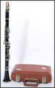 A vintage clarinet musical instrument by Evette complete in fitted case.