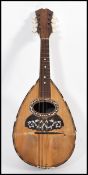 A vintage early 20th century mandolin musical instrument with paper label to interior reading