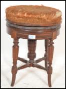 A late 19th century Victorian mahogany inlaid revolving piano stool. The upholstered swivel seat set