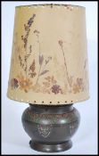 An early 20th century Art Nouveau table lamp. The lamp of bulbous form having enamel armorial