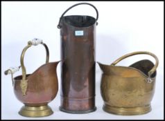 A group of antique fireside items to include two 19th century brass and copper coal scuttle with