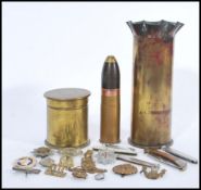 A group of military related items to include various pen knives, cap badges and two artillery