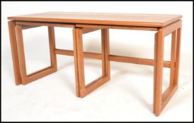 A vintage retro 20th century teak wood nest of tables having a long coffee table with two smaller