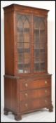 A 20th Century Regency revival mahogany bookcase over chest of drawers. The cabinet having  twin