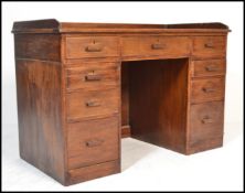 A vintage 20th Century Air Ministry oak twin pedestal desk, the top with inset scribe and gallery