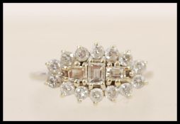 A 20th Century 18ct white gold ring prong set with three rectangular diamonds surrounded by