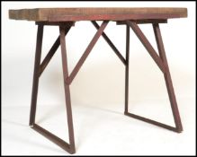 A 20th century Industrial butchers block style work bench. Raised on a cast steel metal a-frame base