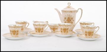 A vintage Noritake bone china coffee service having a pink ground with gilt decoration. Consists