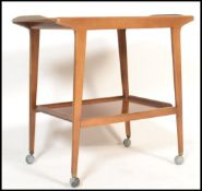 A 1960's retro vintage teak wood two tier cocktail / tea trolley, raised bar handle to one side,