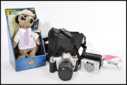 A vintage cased Cannon 35mm camera with a fitted telescopic lens, another Cannon camera and a