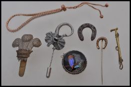 A selection of vintage jewellery items to include a silver white metal hat pin in the form of a