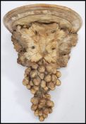A 20th Century cast composite antique style wall bracket / mount in the form of grapes and vine