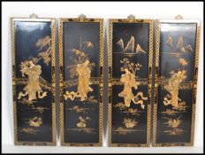 A set of vintage 20th Century four Chinese lacquer wall plaques of rectangular form, having gilt