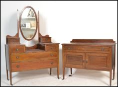 An Edwardian mahogany inlaid dressing table chest being raised on squared legs with castors having a