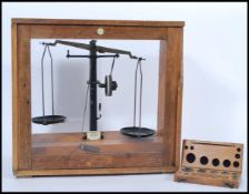 A vintage retro 20th century oak cased set of scientific apothecary weighing balance scales with