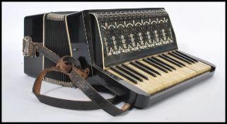 A 20th Century German Fremielio piano accordion having 18 celluloid keys reading Fremielio in