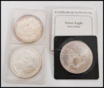 A group of three USA silver Eagle dollars comprising of a 1995 example, 1991 example and an 1987