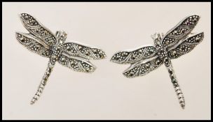 A pair of stamped 925 silver stud earrings in the form of dragonflies set with marcasites. Weight