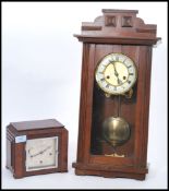 Two vintage early 20th century cased clocks to include a wall hanging mahogany clock with white