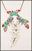 A stamped 925 silver necklace having a pendant in the form of two insects with coloured plique a