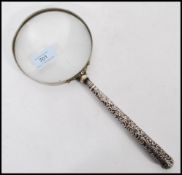 An Edwardian silver handled magnifying glass Adie & Lovekin Ltd., Birmingham 1902, the glass