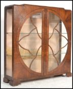 A large early 20th Century 1930's Art Deco mahogany display cabinet raised on block feet with