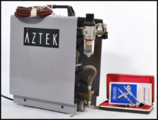 A 20th Century Aztec air brush compressor together with a cased Aerograph Super 63 air brush, the