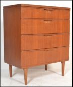 A vintage retro 20th century teak chest of drawers by Austin Suite raised on cylindrical tapered