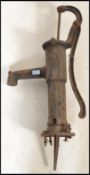 An early 20th century cast and wrought iron village water pump. The painted pump with reeded