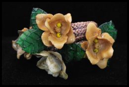 An early attributed Miriam Haskell wrap bracelet having pressed glass leaves and delicate flowers on