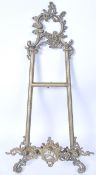 A 19th century Victorian gilt brass table stand / wall mounted picture holder of scrolled form.