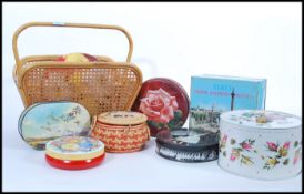 A group of vintage items to include a collection of vintage tins, two woven bags, magazine rack