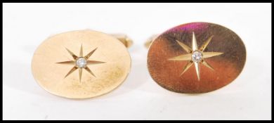 A pair of hallmarked 9ct gold cufflinks cuff links having inset diamonds. Total weight 6.6 grams.