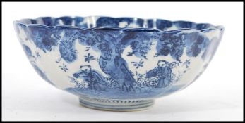 A 19th century Chinese blue and white bowl of scalloped form having hand painted decoration