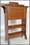 An oak 1920's arts and crafts students bureau having a carved gallery back with a pierced design