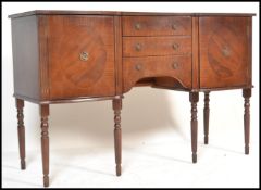 An 20th Century Regency revival mahogany veneered sideboard having brass ring handles and a