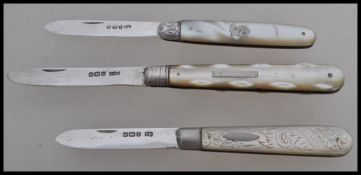 A group of three silver hallmarked and mother of pearl handled fruit pen knives. One hallmarked