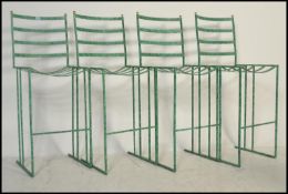 A set of four breakfast / bar / outdoor / garden stools, constructed from metal with ladder back