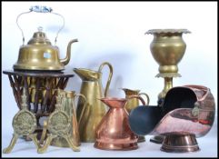 A large collection of vintage copper and brass wares to include a graduating set of brass jugs, blue
