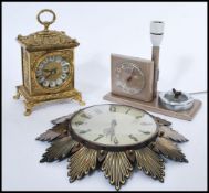 A group of three vintage retro 20th century clocks to include a battery movement antique style brass