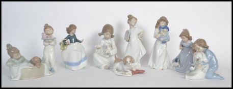 A collection of nao / NAO figurines to include a puppy with a Christmas stocking, a girl with a