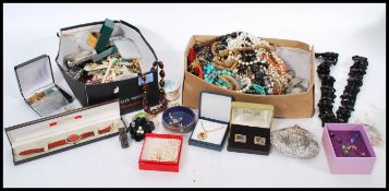 A good selection of vintage costume jewellery to include simulation pearls, a boxed ferrari watch,
