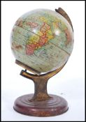A vintage retro mid 20th century 1940's tin desk top globe raised on a circular base. Measures
