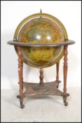 An antique style cocktail drinks cabinet in the form of a globe with hinged top section to fitted
